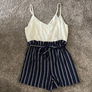 Women short belted jumpsuit with adjustable straps Color Navy blue and white.